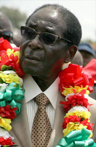 Zimbabwe's President Robert Mugabe wears a garland during a rally held on March 2, 2013 at Chipadze stadium in Bindura as part of the 21st February Movement celebrations held in honor of his 89th birthday. File photo.