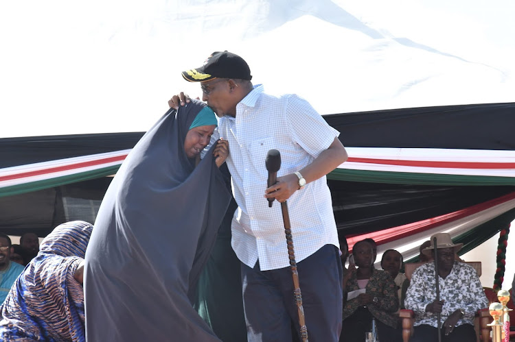 Defence CS Aden Duale consoles a flood victim during the meeting in Garissa