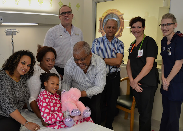 Abongile Ndlovu (foreground) at Netcare uMhlanga Hospital shortly before her discharge. She is pictured with (from left to right) paediatrician, Dr Javeni Govender; her mother, Mrs Prudence Ndlovu; Netcare uMhlanga Hospital general manager, Marc van Heerden; her father, Mr Isaiah Ndlovu; paediatrician, Dr Raj Naranbhai; principal clinical manager of the hospital’s emergency department, Dr Bianca Visser and emergency department nursing sister, Demi du Toit