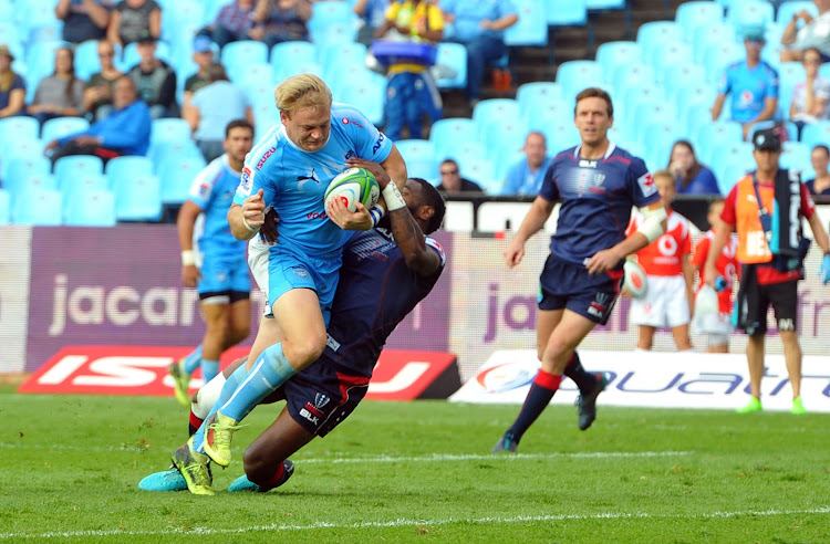 Adriaan Strauss of Bulls is tackled by Marika Koroibete of Rebels during the Super Rugby match between Bulls and Rebels 21 April 2018 at Loftus Versfeld Stadium.