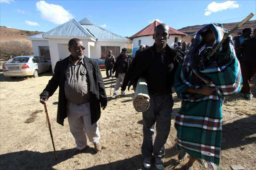 MAKE WAY: Kamva Mphathisi Mantashe is led to the family animal kraal by his traditional nurse Lonwabo Mantashe and father Gwede Mantashe.