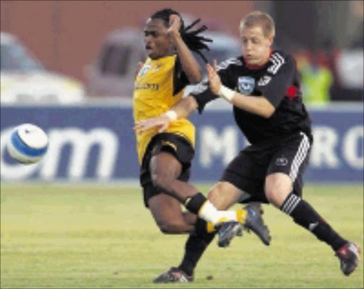 STOP! Kaizer Chiefs' Siphiwe Tshabalala is fouled by Orlando Pirates' Michael Morton during the final of the Telkom Charity Cup at Mmabatho Stadium in Mafikeng on Saturday. Pirates won 1-0. Pic. Antonio Muchave. 02/08/08. © Sowetan.