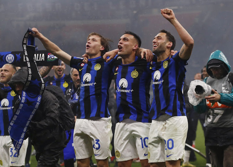 Inter Milan's Nicolo Barella, Lautaro Martinez and Hakan Calhanoglu celebrate winning Serie A after the derby match against AC Milan at the San Siro in Milan on Monday.