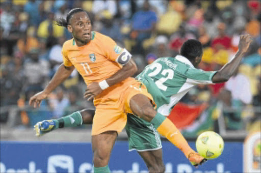 BOWING OUT: Ivory Coast striker Didier Drogba, left, and Nigeria's Kenneth Omeruo fight for the ball during their 2013 Orange Africa Cup of Nations quarterfinal match at Royal Bafokeng Stadium in Rustenburg on Sunday. Photo: Gallo Images