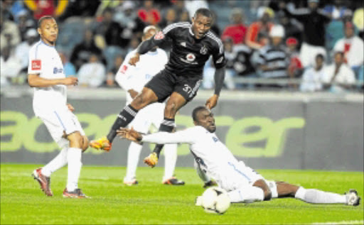 CLOSE, BUT NO CIGAR: Orlando Pirates striker Ranti Tokelo goes past Bidvest Wits' Timothy Batabaire and Katlego Pule in their Premiership match at Orlando Stadium at the weekend. Photo: Gallo Images