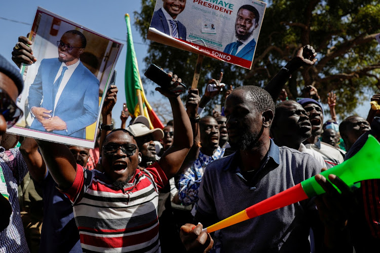 Supporter of jailed Senegalese opposition leader Ousmane Sonko cheer during an electoral campaign caravan in the outskirts of Dakar, Senegal, March 12 2024. Picture: REUTERS/Zohra Bensemra