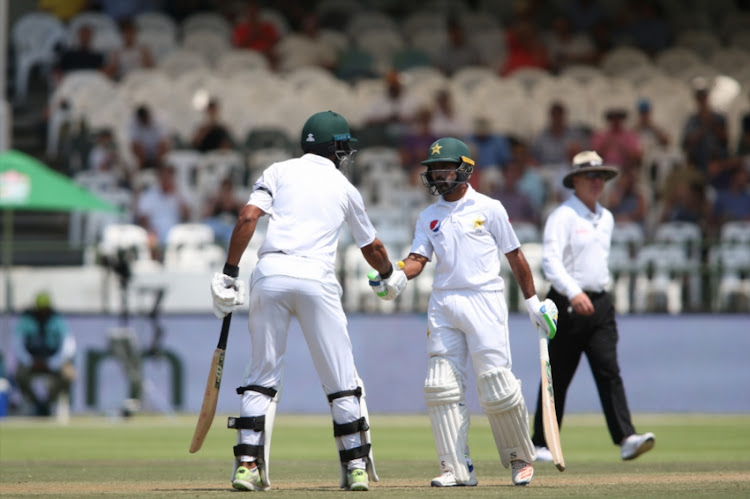 Shan Masood of Pakistan and Asad Shafiq of Pakistan celebrate their 100 partnership during day 3 of the 2nd Castle Lager Test match between South Africa and Pakistan at PPC Newlands on January 05, 2019 in Cape Town, South Africa.