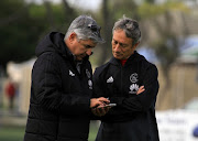 Ajax Cape Town CEO Ari Efstathiou (L) chats to head caoch Mushin Ertugral (R) during the club's training session and press conference at Ikamva on May 09, 2018 in Cape Town, South Africa.