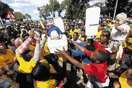 Supporters of the Ses'khona rights movement with a portable toilet and a doll representing Western Cape Premier Helen Zille outside the Belville Magistrate's Court. Ses'khona leaders Andile Lili and Loyiso Nkohla appeared in court charged with dumping human excrement at Cape Town International Airport.