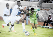 HALTED: SA defender Erick Mathoho, left,  tries to stop Nigerian attacker Ahmed Musa during the  Afcon qualifying  match 
      
        in Uyo on Wednesday. The Group A game ended 2-2
      
      
      
       PHOTO: PIUS UTOMI EKPEI