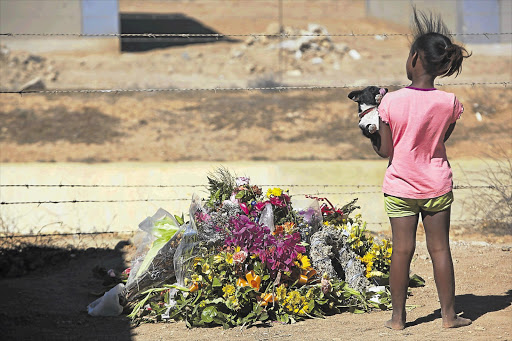 Flowers mark where 17-year-old Anene Booysen was found in Bredasdorp, Western Cape Picture: HALDEN KROG