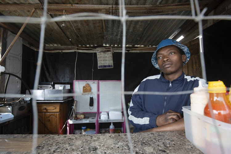 Nkanyiso Mbanjwa, who sells fast food from a stall close to Philani Valley Mall in Umlazi, Durban, lost most of his customers when the shopping centre was torched.