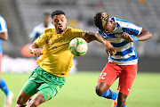 Lyle Foster of South Africa and Prince Balde of Liberia during the 2023 Africa Cup of Nations qualifier match between South Africa and Liberia at Orlando Stadium on March 24, 2023 in Johannesburg.