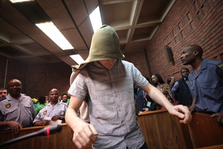 The man accused of raping a seven-year-old leaves the court room in the Pretoria magistrate's court on November 1 2018. The tattoo of the Serenity Prayer can be seen on his left arm.