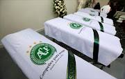 Blankets bearing the crest of Brazilian soccer team Chapecoense are placed on coffins holding the remains of the victims who died in an accident of the plane that crashed into the Colombian jungle with the team's players onboard, in Medellin, Colombia December 1, 2016.