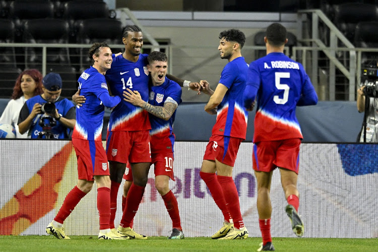 US midfielder Haji Wright (14), forwards Josh Sargent (11), Brenden Aaronson (11), Christian Pulisic (10) and Ricardo Pepi (9) and defender Antonee Robinson (5) celebrate after Wright's game-winning goal against Jamaica during extra time at the AT&T Stadium in Arlington Texas