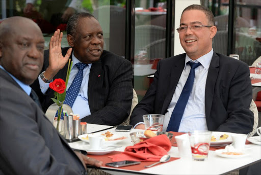 Issa Hayatou (2nd-L), CAF president, speaks to Fouzi Lekjaa (R), President of the Moroccan Football Federation (FRMF), during breakfast on November 3, 2014 in Rabat, ahead of their meeting to discuss Rabat's request to postpone hosting the 2015 Africa Cup of Nations due to the Ebola epidemic