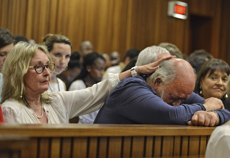 Barry Steenkamp, father of Reeva Steenkamp, is consoled by his wife June Steenkamp during the sentencing hearing of Olympic and Paralympic track star Oscar Pistorius at the North Gauteng High Court in Pretoria on October 15 2014. File photo.