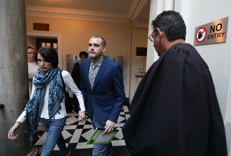 Henri van Breda and his girlfriend Danielle Janse van Rensburg leave the court room for tea break.