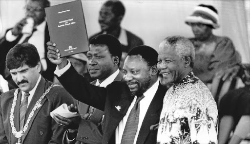 President Mandela with a copy of the new constitution in 1996