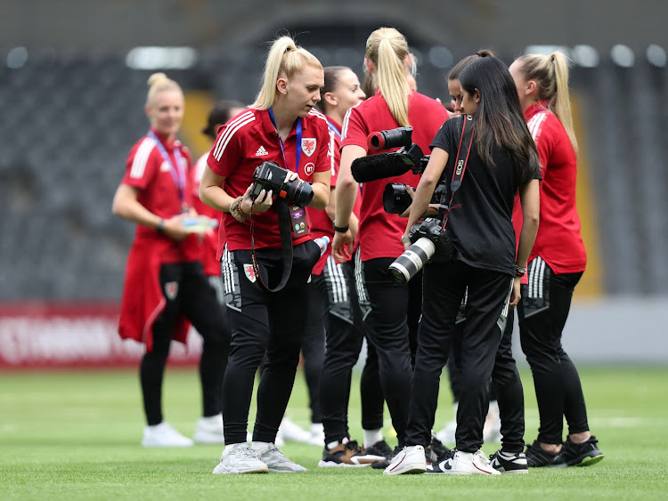 Wales' players hold cameras before a recent match