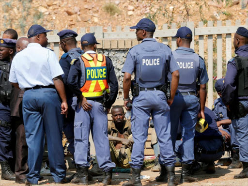 South African police question a miner during a previous protest in Langlaagte on September 12, 2016 /REUTERS