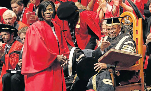 PEOPLE'S CHAMPION: Rhodes University Chancellor Justice Lex Mpati pays tribute to public protector Thuli Madonsela who was given a long standing ovation when she received an honorary doctorate of laws Picture: PHOTO FIRST