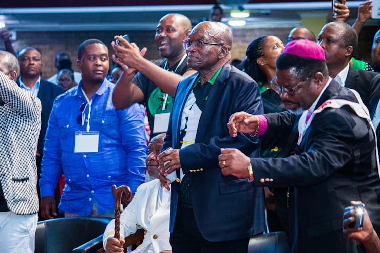 Former president Jacob Zuma dances with chuch leaders during a service at the Rivers of Living Waters Ministries church.