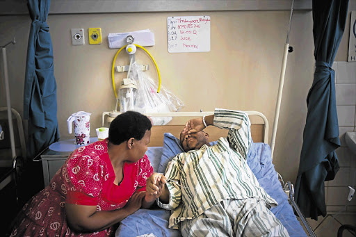 Aurora mine worker Thatoyaone Motlogelwa and his wife, Selina Mofokeng, at Tshepong Hospital near Orkney, North West yesterday after he suffered a diabetic attack on Monday Picture: DANIEL BORN