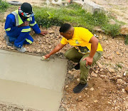 Avela Mjajubana has caused a stir by adding spice while on the campaign trail, seen here helping with some plastering