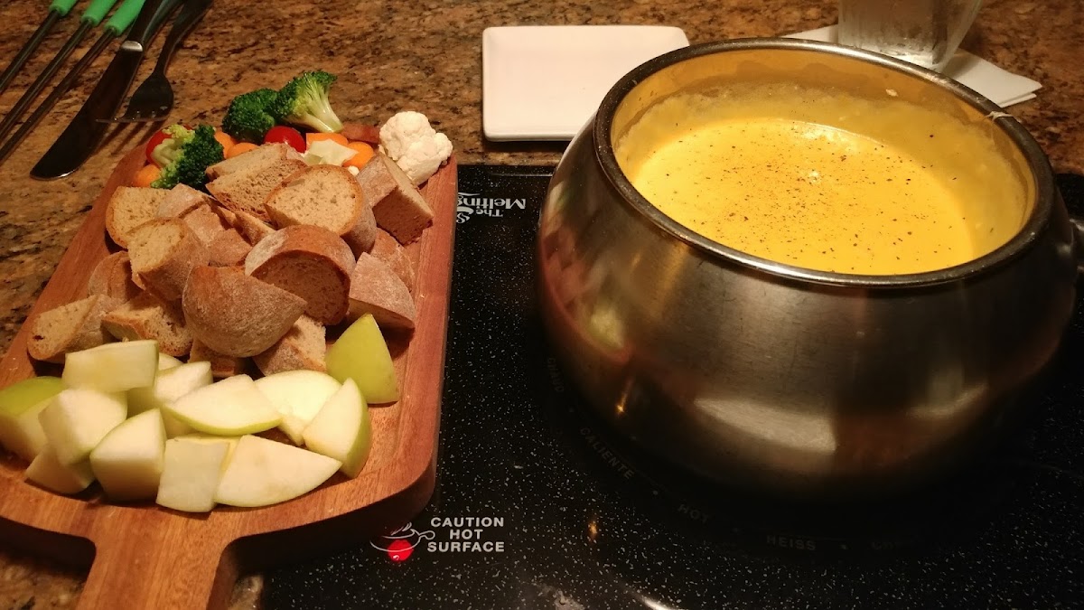 Wisconsin Cheddar cheese fondue with gluten free dipper plate. Fondue is gluten free with substitution of Red Bridge beer.