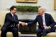 US President Joe Biden shakes hands with Iraqi Prime Minister Mohammed Shia al-Sudani in the Oval Office at the White House in Washington DC, US, on April 15 2024.