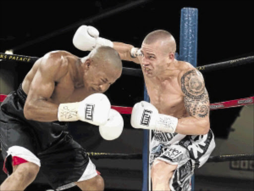 Take that! Warren 'The Warrior' Joubert punishes Lungisa Jikani in their clash for the vacant SA junior welterweight title, which Joubert won by a wide margin at Emperors Palace on Monday night PHOTO: n-Squared