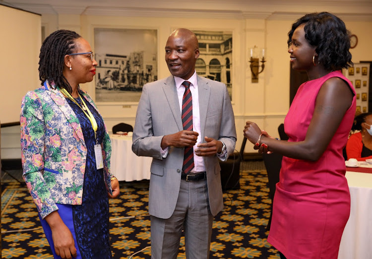 Kenya Film Commission (KFC) CEO Timothy Owase (Center) chats with Edna Oyori, KFC Finance Manager (L) and Letitia Ouko, Corporate Communication Manager, KFC during the announcement ceremony for the nominees for the 11th edition of the Kalasha Awards at The Sarova Stanley, Nairobi.