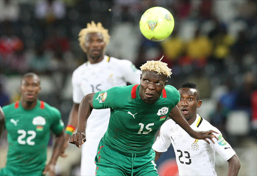 Bance Aristide of Burkina Faso wins possession from Ghana players during the semi final of the Africa Cup of Nations at Mbombela stadium, Nelspruit. PIC: SYDNEY SESHIBEDI. 06/02/2013. © The Times
