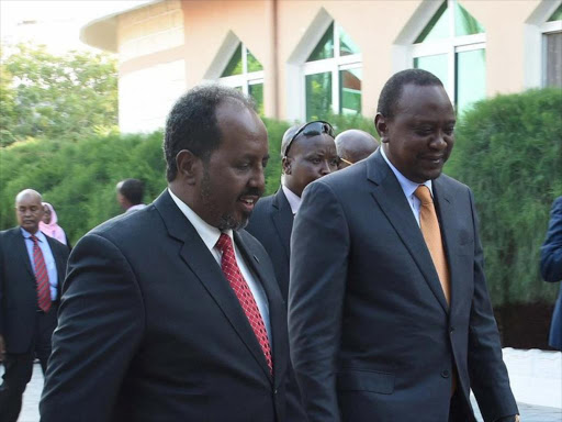 President Uhuru Kenyatta and his Somalia counterpart xyxyx at the sidelines of IGAD meeting in Mogadishu on Tuesday, September 13. /PSCU