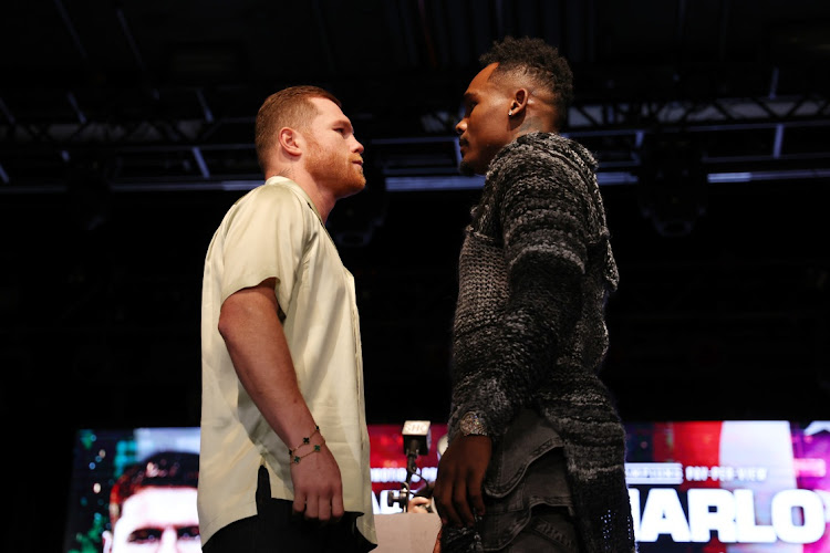 Canelo Alvarez of Mexico (L) and Jermell Charlo (R) face off during a press conference to preview their September 30 super middleweight undisputed championship fight
