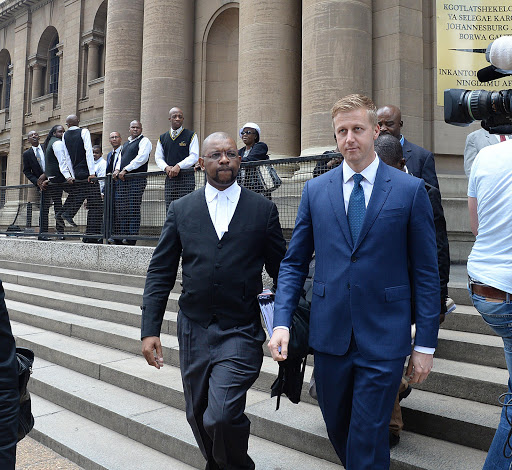 Gareth Cliff leaves court with his lawyer, Advocate Dali Mpofu.