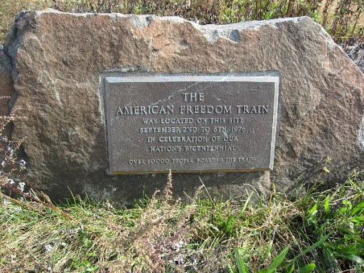 “The American Freedom Train was located on this site Sept. 2-6th in celebration of our nation’s Bicentennial. Over 60,000 people boarded the train.”The plaque, which is believed to have placed by...