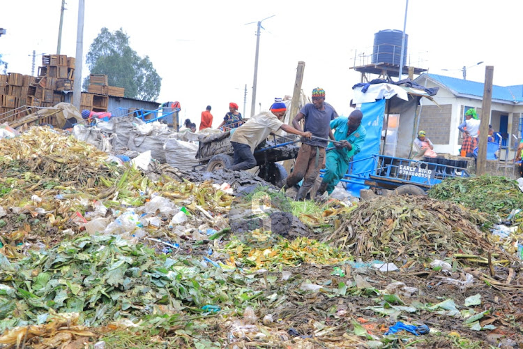 Garbage collectors dump wastes a Muthurwa Market on April 16, 2024.