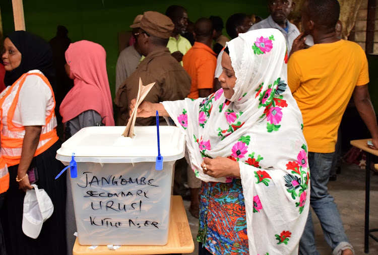 A Tanzanian government worker casts her ballot at a polling centre during the early voting for essential workers at the presidential and parliamentary polls in the semi-autonomous island of Zanzibar, Tanzania October 27, 2020. REUTERS