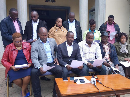 Kangundo Central MCA Moses Musyoka (3rdL seated) issues a press statement flanked by his colleagues at Machakos County Assembly premises in Machakos town on Monday./George Owiti