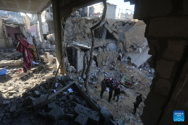Palestinians inspect the debris of a building after Israeli airstrikes in the southern Gaza Strip city of Rafah, February 3, 2024.