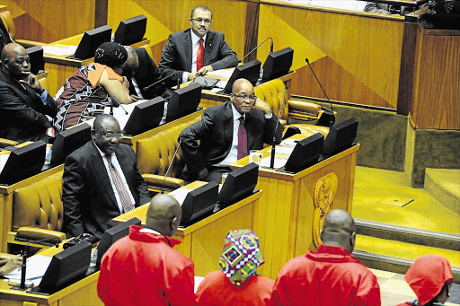 President Jacob Zuma watches EFF MPs being sworn in last year. Zuma delivers his State of the Nation speech tomorrow