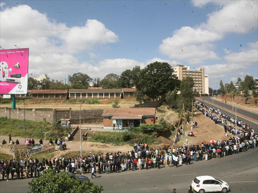 Voters queue waiting the for their chance to cast their votes at the Moi avenue primary school Mar 04 2013.Photo/HEZRON NJOROGE