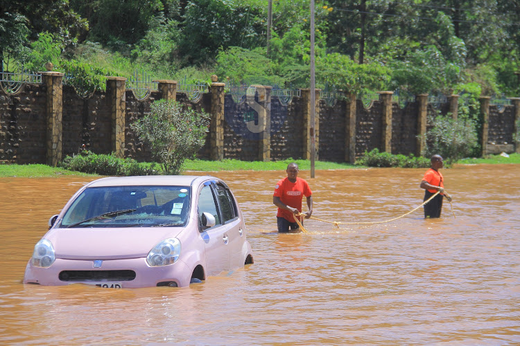 Rescuers try to pull a stalled car out of flood waters on Thika Superhighway, May 1, 2024.