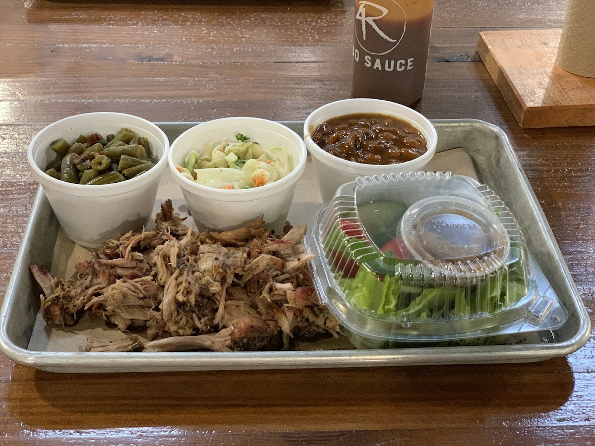 Pulled pork platter with green beans, coleslaw, bbq baked beans, and side salad.