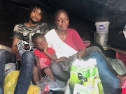 'Leaders explained to us that we are not allowed to cook and wash outside, but I am a human being. I still need to eat and wash,' said Suzanne Kabasele, pictured above with her son and brother in-law Melchi Kazadi. 