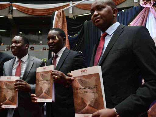 Mining CS Dan Kazungu, his Devolution counterpart Mwangi Kiunjuri (C) and Planning and Statistics PS Irungu Nyakera during the launch of the 2017 Economic Survey report in Nairobi yesterday /FAITH MUTEGI