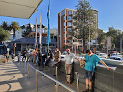 Queues of liquor shoppers outside Checkers Liquors in Cape Town CBD.